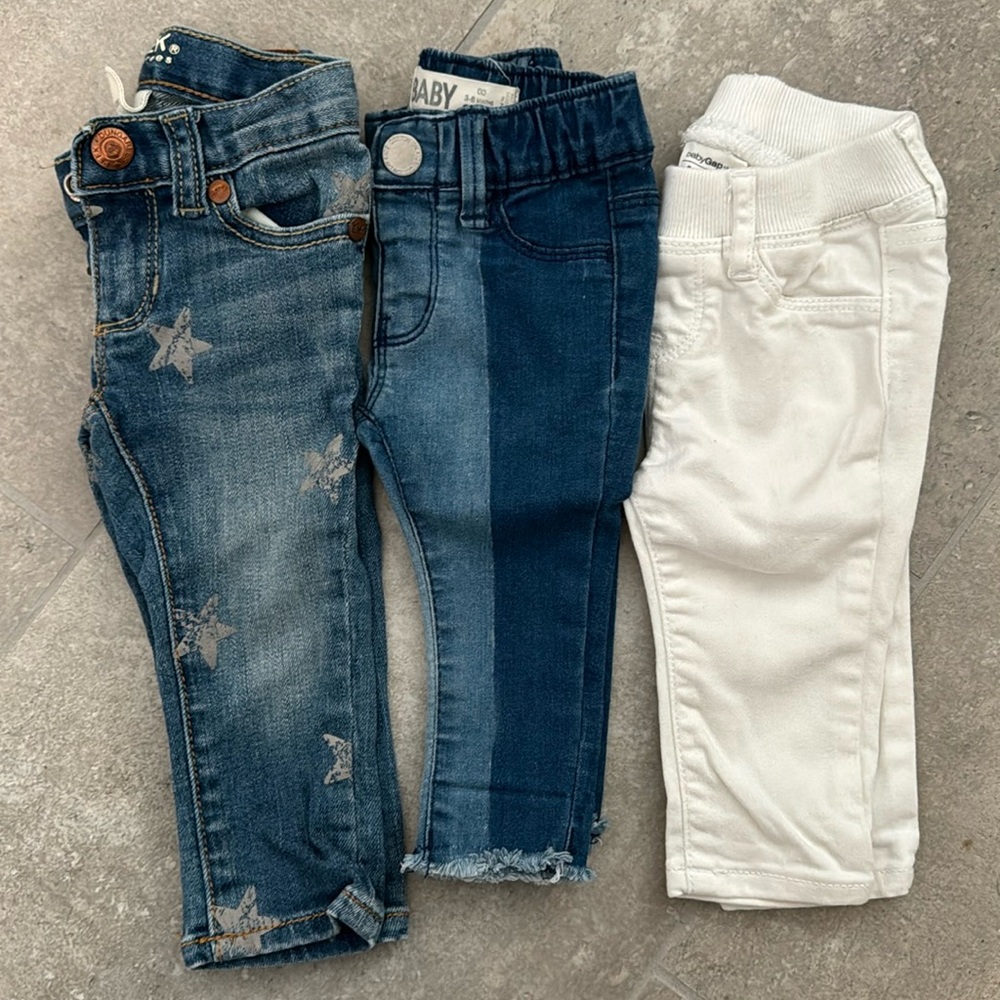 Three pairs of baby jeans.